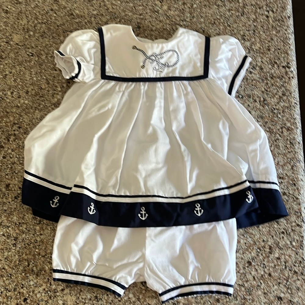 Girls sailor dress with navy blue edge and embroidery details size:9m